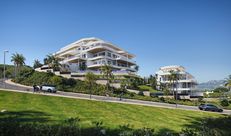 360 By Cordia – Mijas - exterior facade of luxury white curved residential buildings set on a hillside with palm trees, landscaped gardens and mountain views