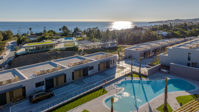 Evergreen Homes – El Chaparral - aerial view of luxury new-build villas with communal pool and sea views, Málaga