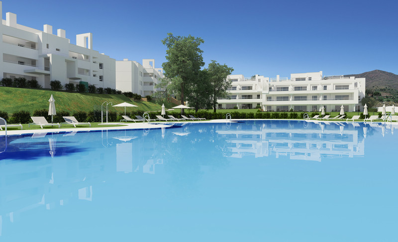 SOLANA VILLAGE – La Cala Golf - large communal swimming pool with white apartment buildings and green hillside backdrop