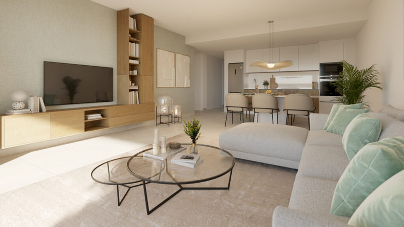Aire – Cancelada - lys åpen stue med stor sofa, glassalebord og åpent kjøkken i bakgrunnen
