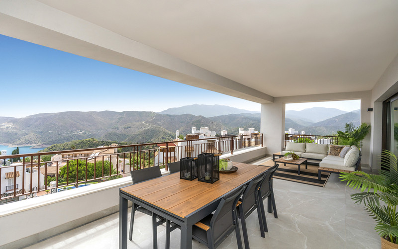 Almazara Forest + Gardens – Istán - spacious covered terrace with dining area, lounge seating and panoramic mountain and lake views