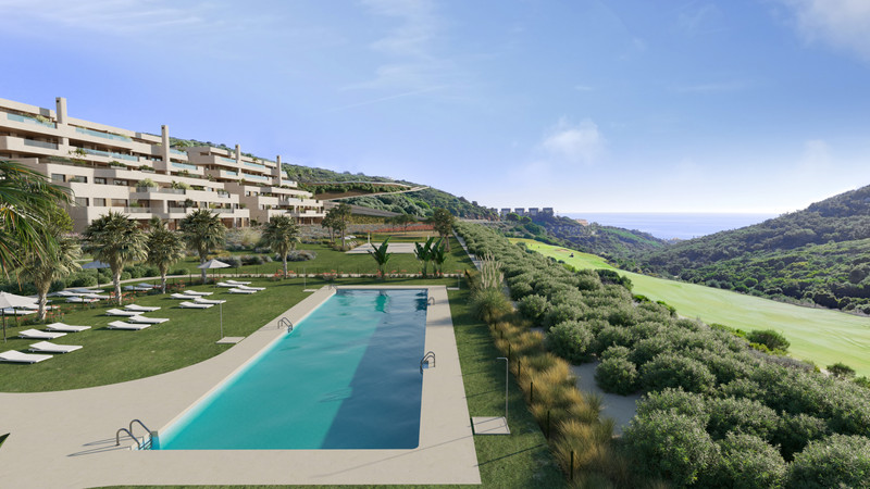 Atria – Phase 2 – La Alcaidesa - outdoor swimming pool, landscaped gardens and terraced residential buildings overlooking a golf course and sea views