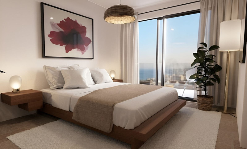 Casa 2 – Bougaivillea Rosa – Torreblanca - elegant bedroom with sea views, warm wood platform bed and floor-to-ceiling balcony doors