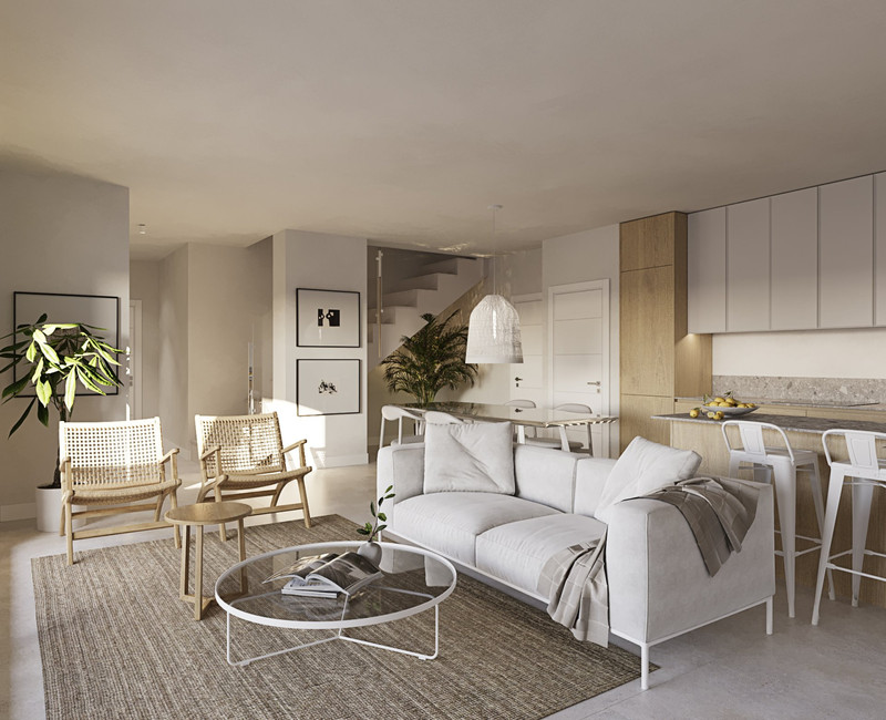 Casares Bay – Casares - lys åpen stue og spiseplass med hvit sofa, rottingstolar og moderne kjøkken