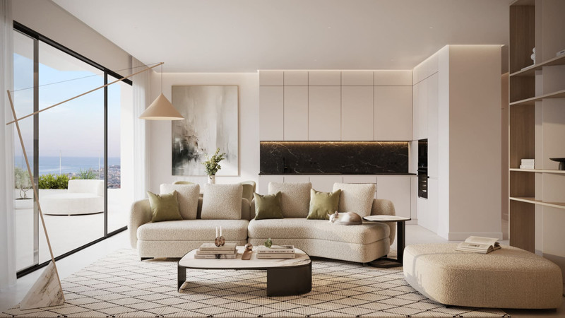 Horizonte Village – The Residences – Mijas - lys åpen stue med krem bouclé-sofa, grønne puter, marmorbar og panoramisk havutsikt