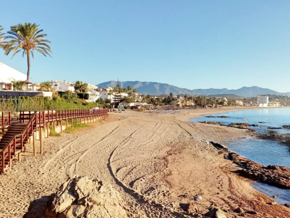 La Cala de Mijas coastline, golden beach and town centre with hills behind