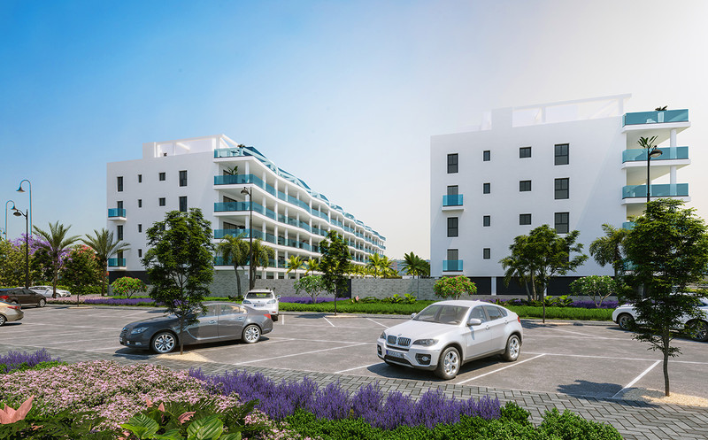 Jardines de Las Lagunas Fase II – Las Lagunas - fasade med moderne hvite leilighetsbygg, teal-balkonger og landskapsbehandlet parkeringsplass
