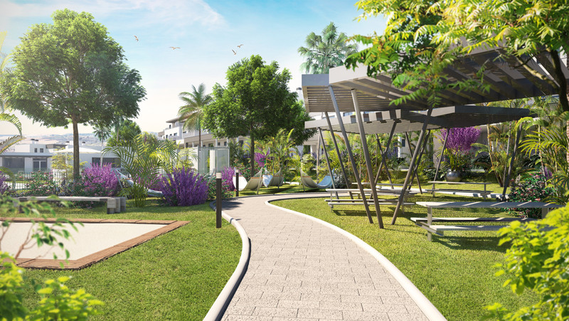 Habitat Valle Romano – Estepona - hage med slynget sti, pergola, solstoler og frodig tropisk beplantning