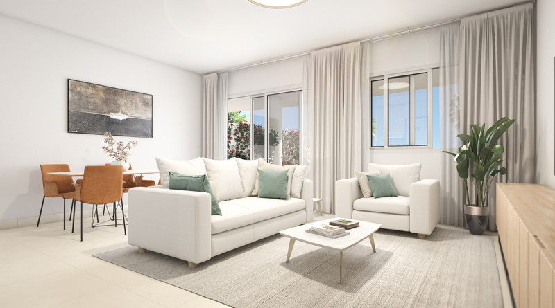 Nexus Residences – Benalmadena – lys åpen stue med hvite sofaer, grønne puter og utsikt mot hagen