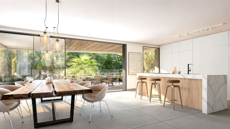 Palm Residences – New Golden Mile - åpen kjøkken- og spisestue med marmorøy, live-edge-bord og hageutsikt