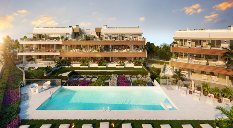 Quintessence – Altos de los Monteros - luxury new-build exterior with communal infinity pool, terraced gardens, and modern residential blocks at golden hour