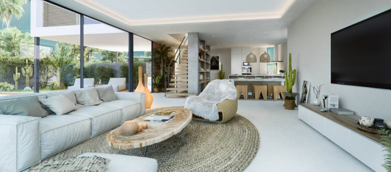 Sanctuary Villas II – El Paraiso - åpen stue med naturlig trekaffebord, rottingmatte og gulv-til-tak glassdører mot frodig hage