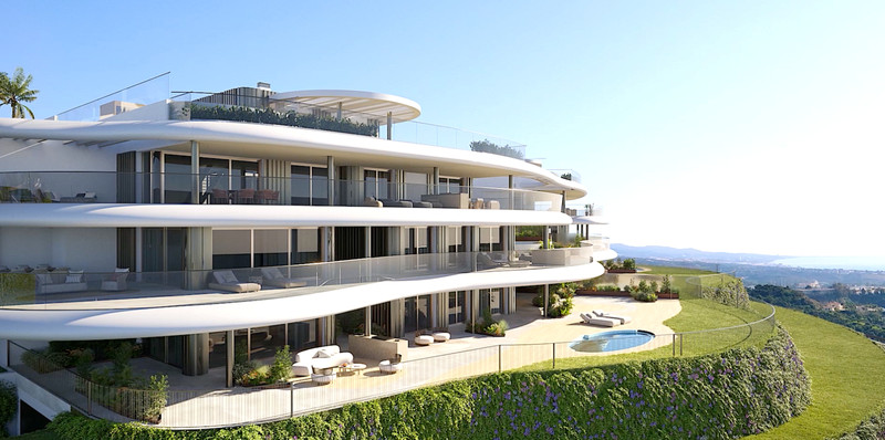 The Sky Marbella Leilighets – Benahavís - curved white facade with wraparound terraces, pool, and panoramic sea views