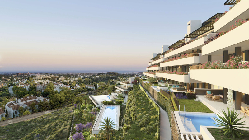 Tiara – Benahavís - terraced luxury apartments with cascading pools, lush gardens and panoramic Costa del Sol views at dusk