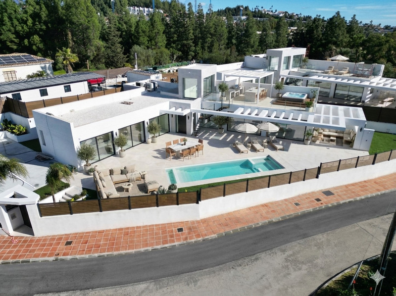 Chaparral Sunset Villas – El Chaparral - aerial view of modern white villa with outdoor pool, terrace, and landscaped garden