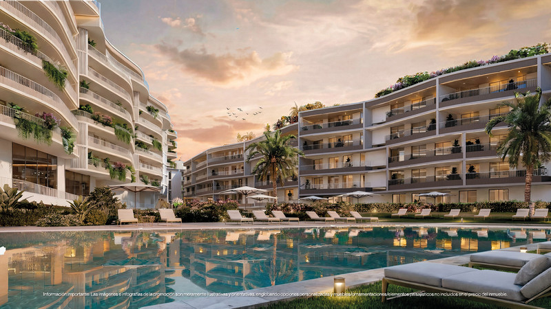 Magna Torremolinos – Torremolinos - luxury residential complex with curved balconies, lush greenery, and a reflective outdoor pool at sunset