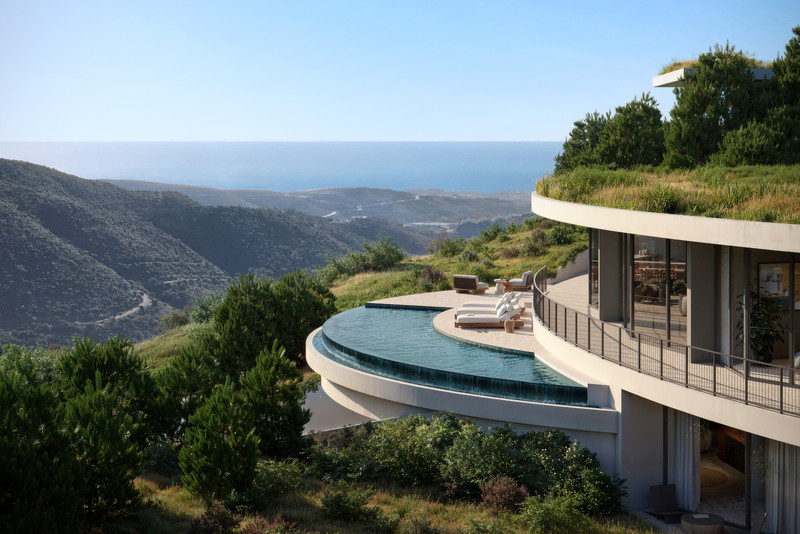 Villa I3 – Vitae Villas – Benahavís - curved infinity pool terrace with sun loungers and panoramic hillside sea views