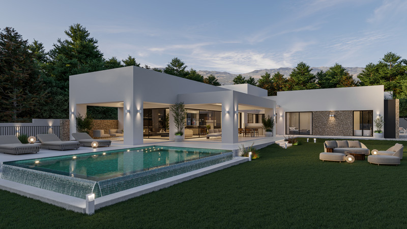 Villa Carolina – New Golden Mile - modern white villa exterior with illuminated pool, waterfall feature, and landscaped garden at dusk