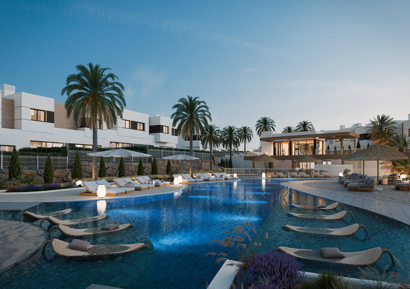 Savia – Fase 1 – Mijas - luxury outdoor swimming pool with sun loungers, palm trees and modern white residential buildings at dusk