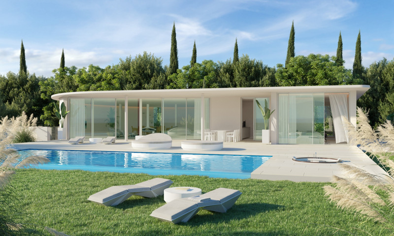 The Bay 7 – Benalmadena - modern white villa exterior with rectangular swimming pool, sun loungers, and lush garden
