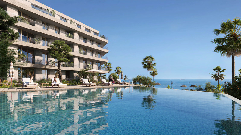 Vesta Mare – La Duquesa - infinity pool with sun loungers, palm trees and Mediterranean sea views beside a modern residential building