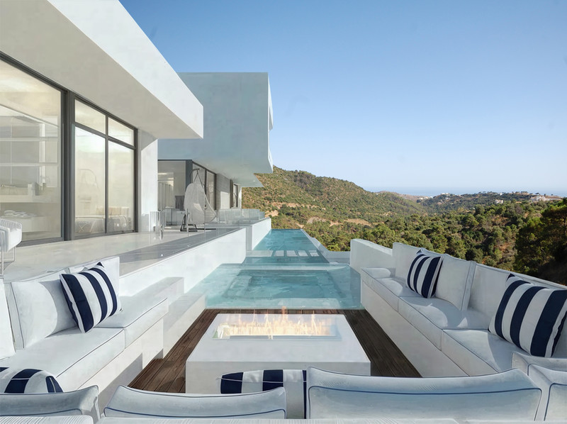 Zoe Luxe – Benahavís - infinity pool terrace with white outdoor seating, fire pit and panoramic hillside views